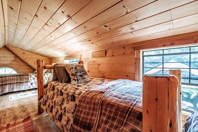 bedroom featuring hardwood / wood-style floors, vaulted ceiling, and wood ceiling