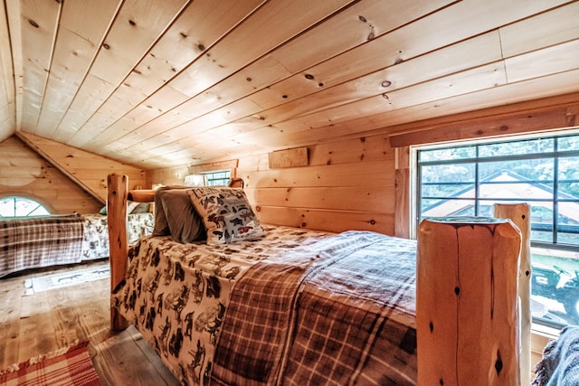 bedroom with vaulted ceiling, hardwood / wood-style floors, wooden ceiling, and wood walls