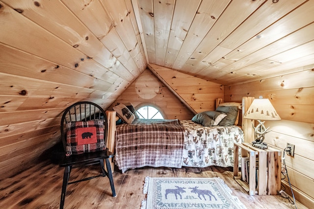 bedroom featuring wood ceiling, vaulted ceiling, hardwood / wood-style flooring, and wood walls