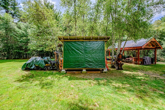 view of yard featuring a gazebo and an outbuilding