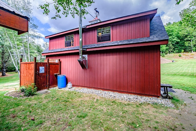 rear view of property featuring a lawn