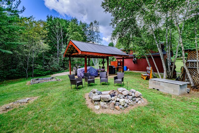 view of yard featuring an outdoor living space with a fire pit and a gazebo