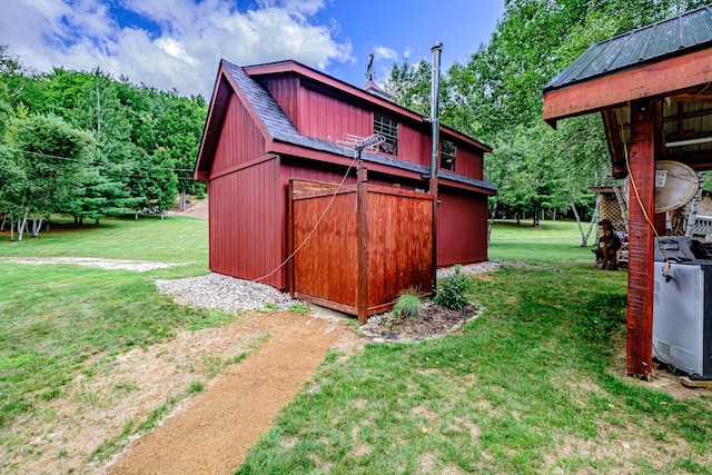 view of outbuilding with a lawn