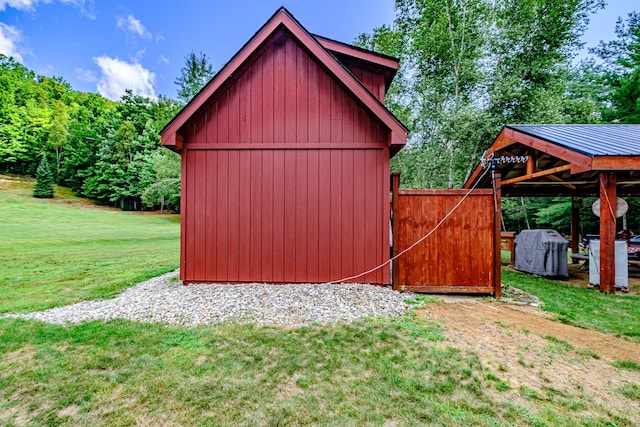 view of outbuilding with a yard