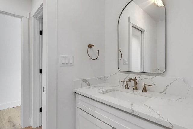 bathroom with vanity and hardwood / wood-style flooring