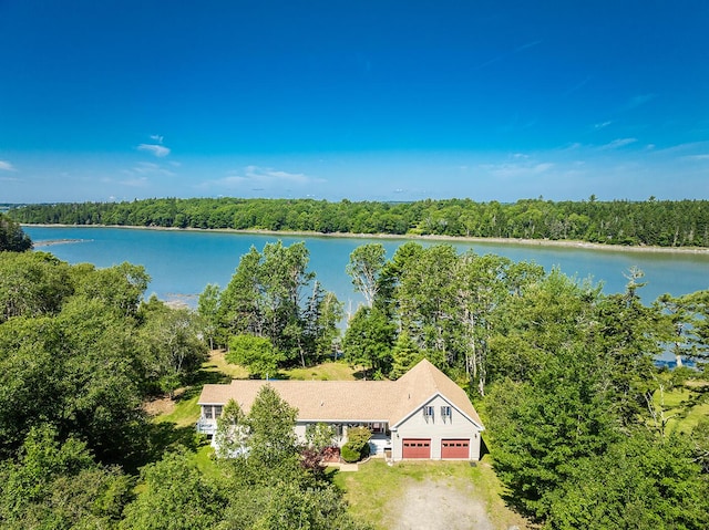 aerial view featuring a forest view and a water view