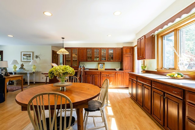 dining area with light wood-style flooring and recessed lighting