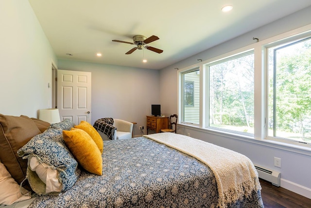 bedroom featuring dark wood-style flooring, recessed lighting, a baseboard heating unit, ceiling fan, and baseboards