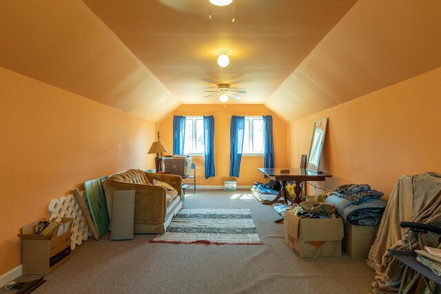 additional living space with vaulted ceiling, carpet, a ceiling fan, and baseboards