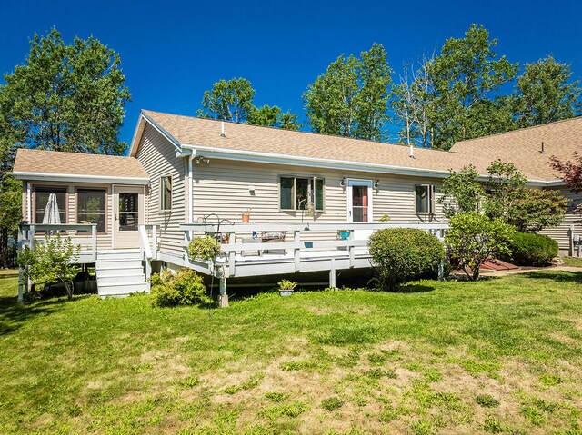 view of front of property featuring a front yard and a deck