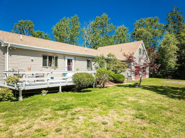 back of house with a yard and a wooden deck