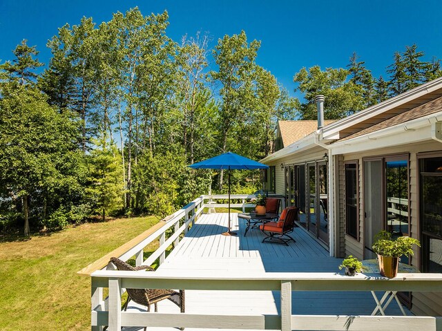 wooden terrace with a lawn