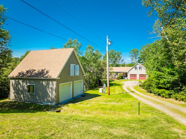 view of home's exterior featuring a lawn and a garage