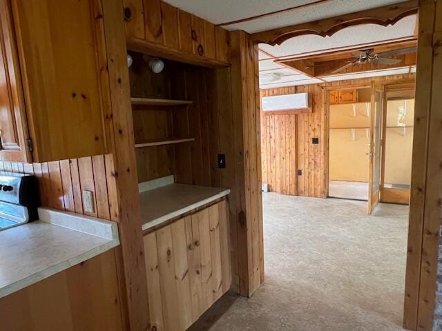 interior space featuring a wall mounted air conditioner and ceiling fan