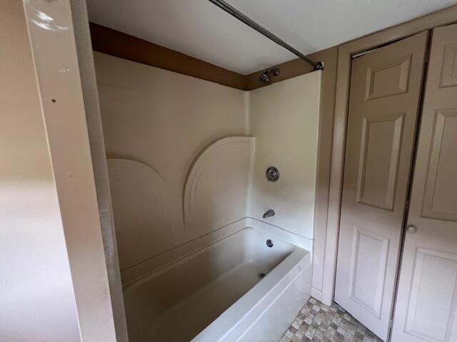 bathroom with shower / bath combination and tile patterned floors