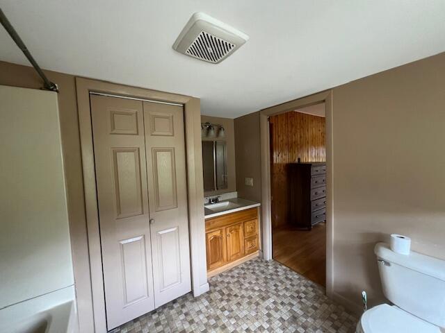 full bathroom featuring tile patterned flooring, toilet, vanity, and tub / shower combination