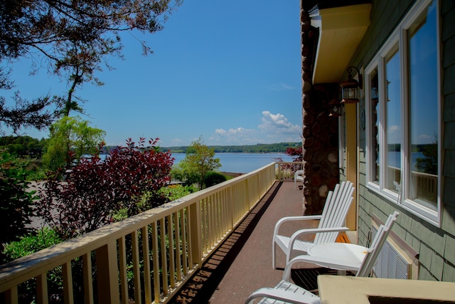 balcony featuring a water view