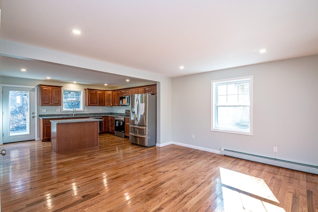 kitchen featuring a center island, hardwood / wood-style flooring, and stainless steel appliances