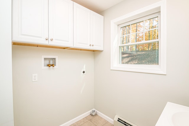 washroom with electric dryer hookup, washer hookup, baseboard heating, light tile patterned floors, and cabinets