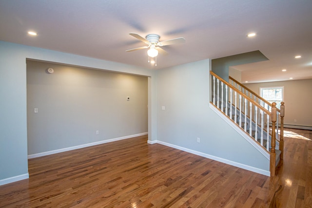 spare room with dark wood-type flooring and ceiling fan