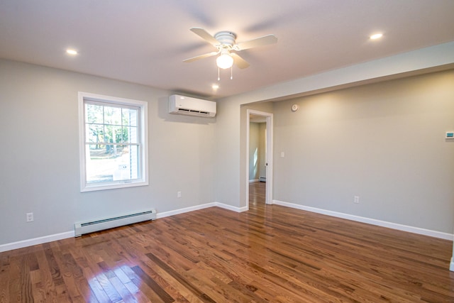 spare room with dark wood-type flooring, a baseboard heating unit, a wall mounted air conditioner, and ceiling fan