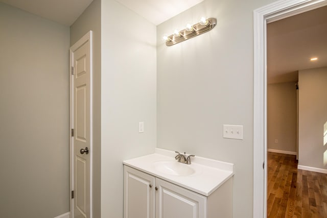 bathroom with vanity and hardwood / wood-style flooring