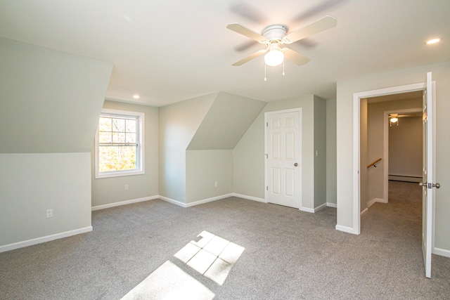 bonus room with light carpet, lofted ceiling, and a baseboard radiator