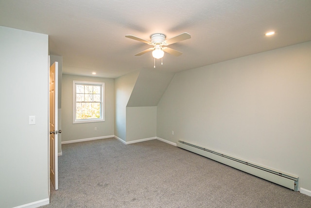 additional living space with baseboard heating, vaulted ceiling, light colored carpet, and ceiling fan