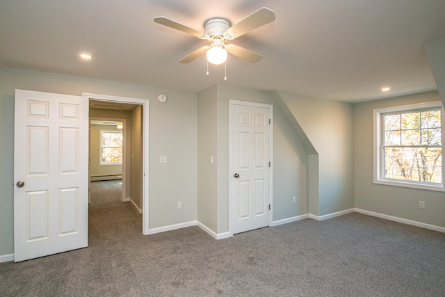 bonus room featuring ceiling fan, carpet floors, and a baseboard heating unit