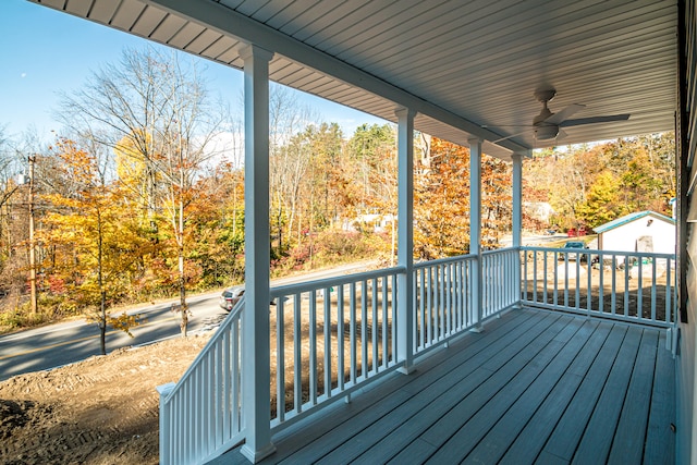 deck featuring an outbuilding and ceiling fan