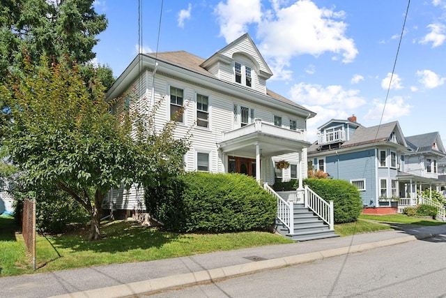 view of front of home with a porch and a front yard