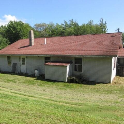 back of property featuring a yard