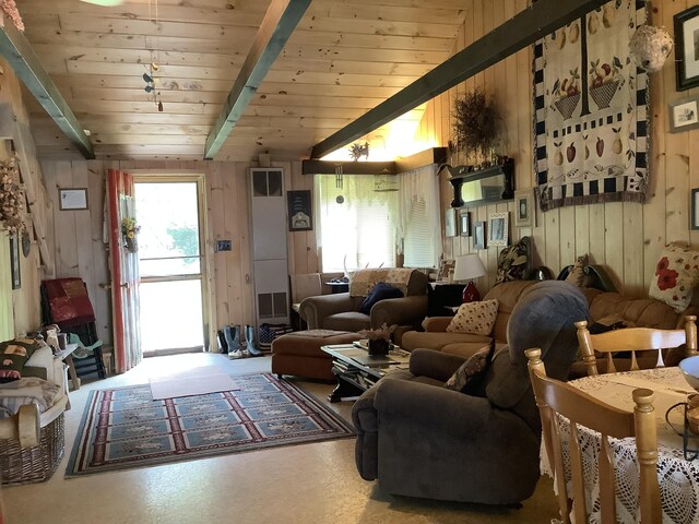 living room featuring lofted ceiling with beams, wood ceiling, and wood walls