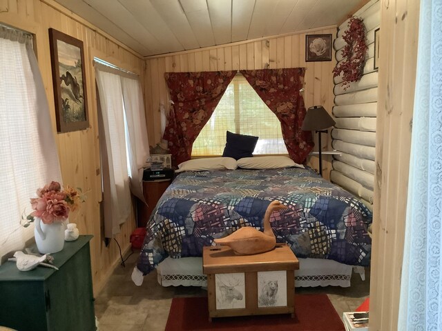 bedroom with wooden walls and vaulted ceiling