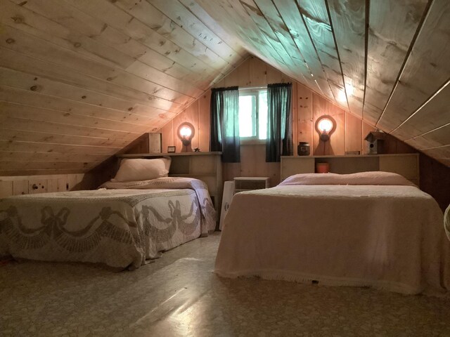 bedroom featuring wooden ceiling, lofted ceiling, and wood walls