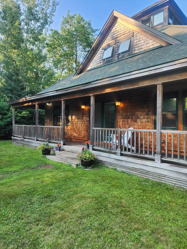 exterior space with a porch and a front yard