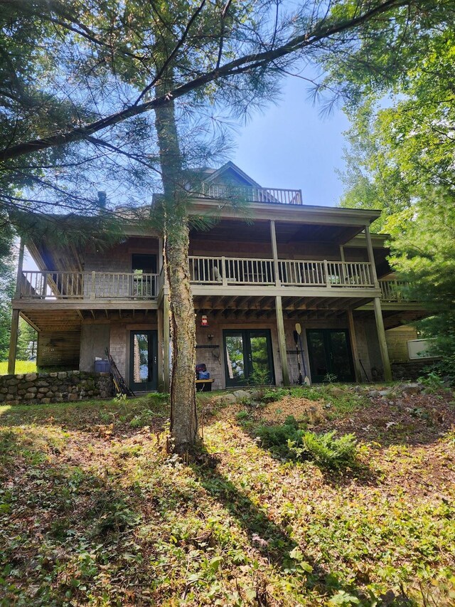 rear view of property with a balcony