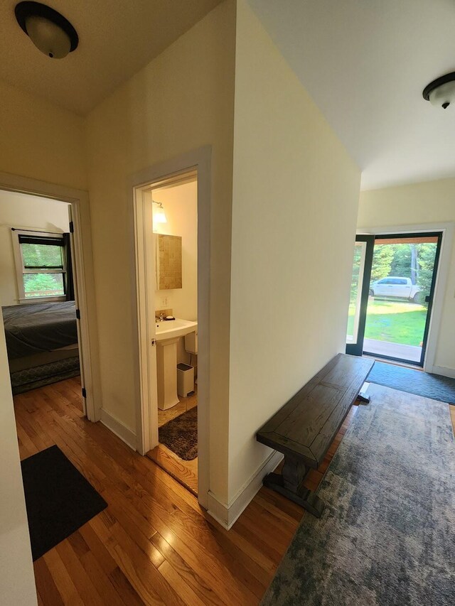 corridor with hardwood / wood-style floors