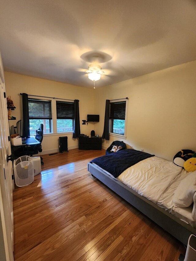 bedroom with wood-type flooring and ceiling fan