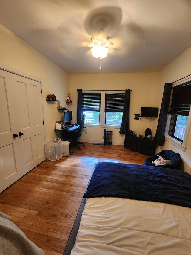 bedroom with ceiling fan and light wood-type flooring