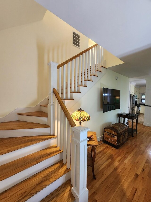 stairs with hardwood / wood-style flooring