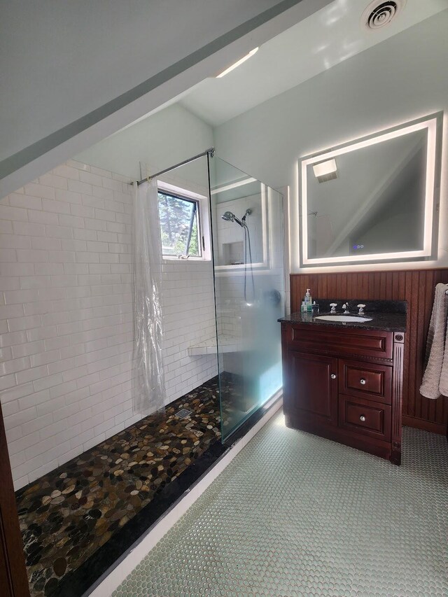 bathroom featuring tiled shower, tile patterned flooring, and vanity