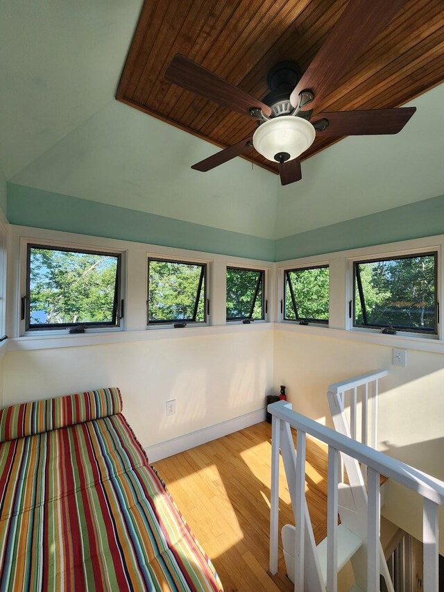 bedroom featuring light hardwood / wood-style flooring, multiple windows, ceiling fan, and vaulted ceiling