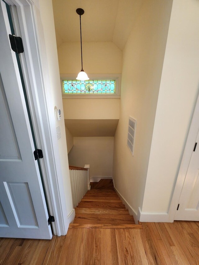 stairs featuring light hardwood / wood-style floors