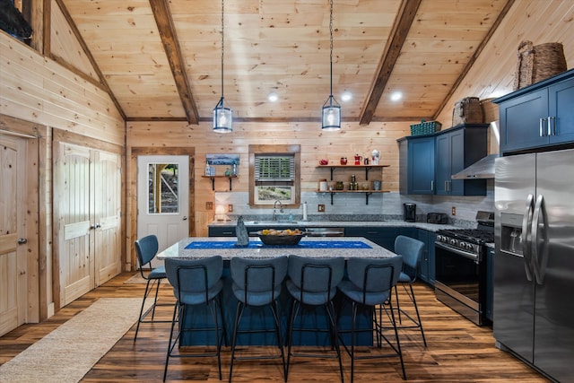 kitchen with a center island, wood walls, stainless steel appliances, wooden ceiling, and hardwood / wood-style flooring