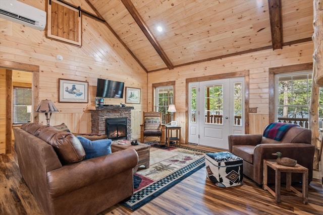 living room with wood walls, a wall mounted air conditioner, wood-type flooring, and plenty of natural light