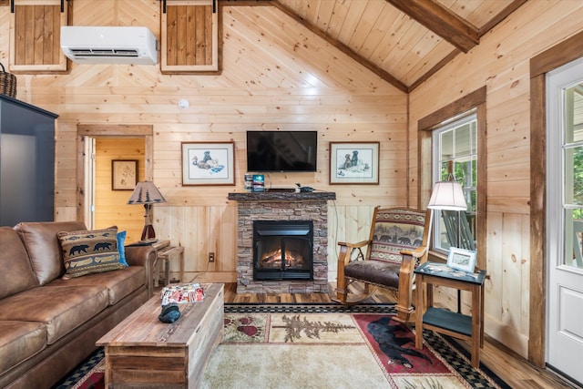 living room with vaulted ceiling with beams, wood walls, a wall mounted AC, a fireplace, and wood-type flooring