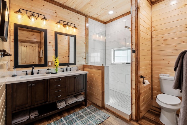 bathroom with wood ceiling, tiled shower, toilet, hardwood / wood-style flooring, and double sink vanity