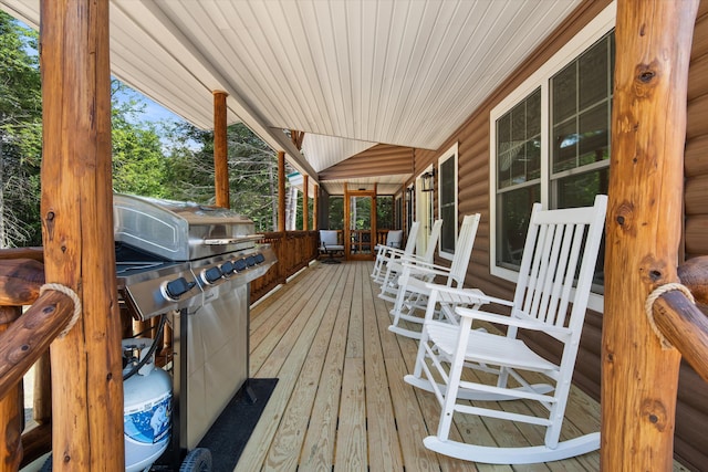 wooden deck featuring a grill