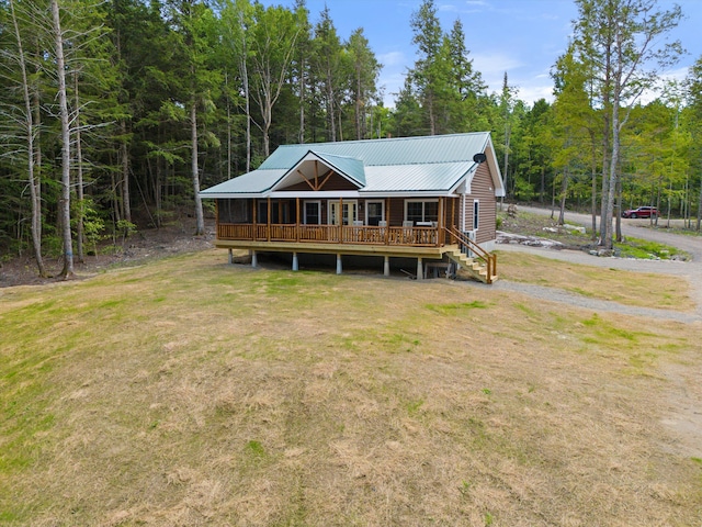 rear view of house featuring a yard